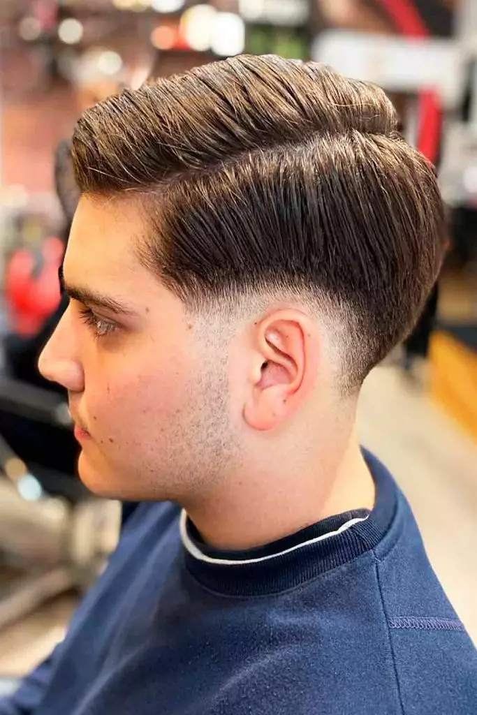low drop fade comb over on straight hair with hard part and sharp lineup
